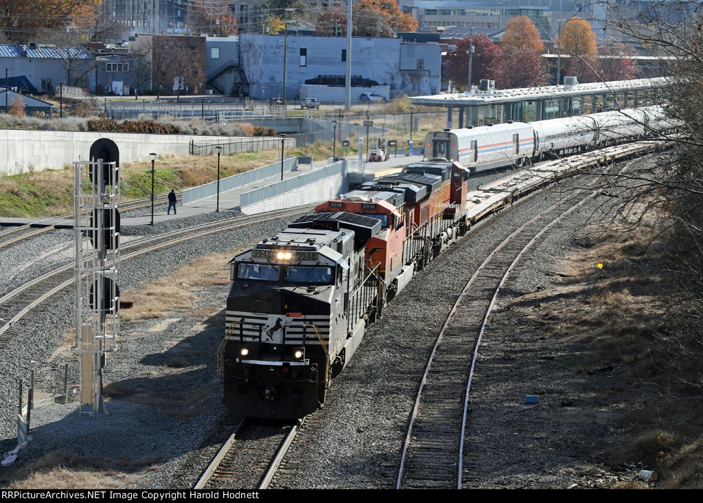 NS 9948 leads train O56 past train P080-28 in the station